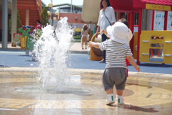 噴水で遊び小さな子