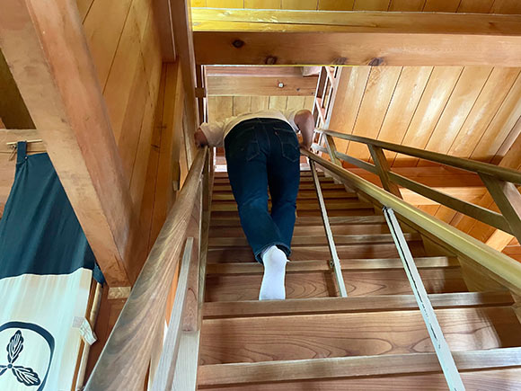 急な階段をのぼる男性